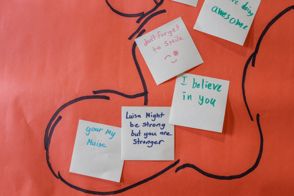 Encouraging notes written by Guadalupe School students saying, "You're my muse," "I believe you," "Don't forget to smile," and "Luisa (from Encanto) might be strong but you are stronger."